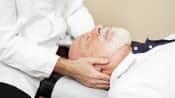 Chiropractor adjusting patient&#039;s neck