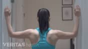 Woman doing the corner neck stretch