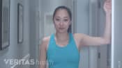 Woman starting the levator scapula stretch