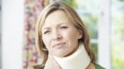 Woman with neck pain wearing a neck brace