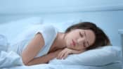 Woman lying prone asleep on her pillow.