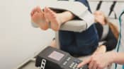 Patient lying supine while spinal decompression therapy is administered.