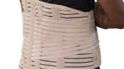 Man&#039;s torso with a lower back brace over his shirt