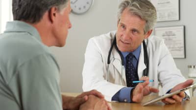 Doctor and patient having a discussion in an office.