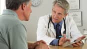 Doctor and patient having a discussion in an office.