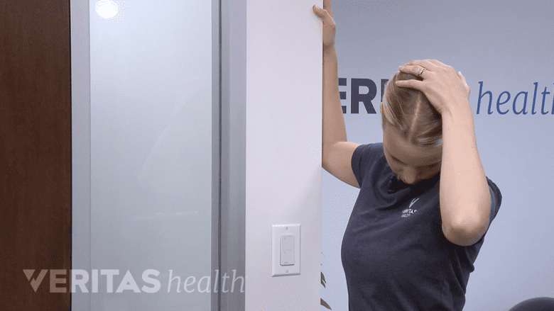Photo of a physical therapist holding a neck stretch.
