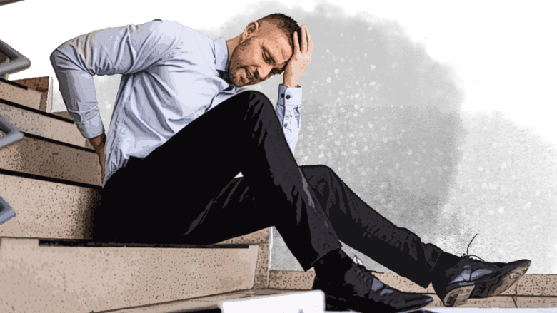 A man sitting on stairs with his hand on his back.