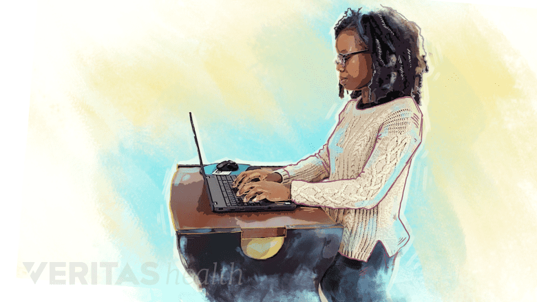 A woman using a standing desk.